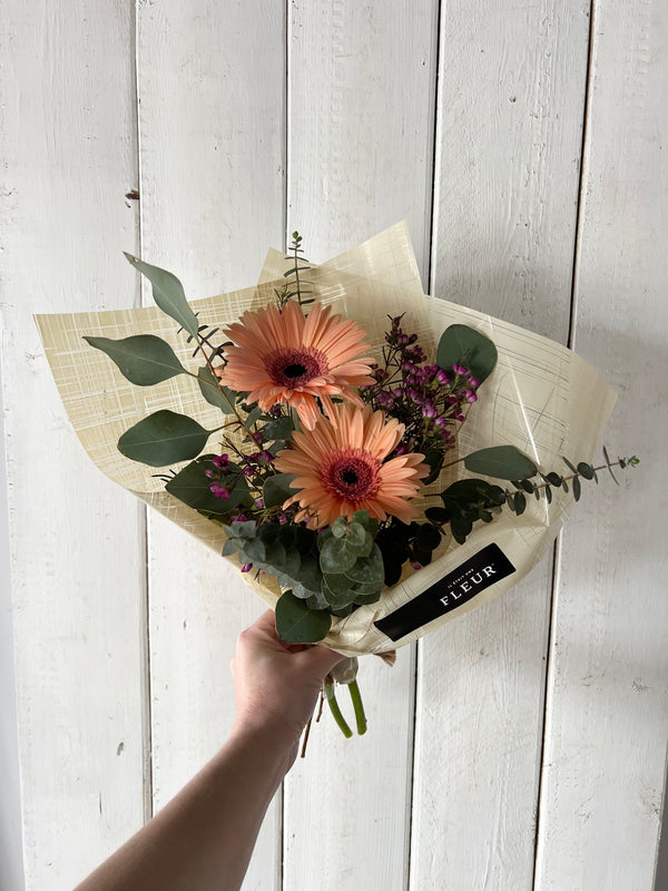 Cute seasonal flower bouquet with accompanying flowers and eucalyptus